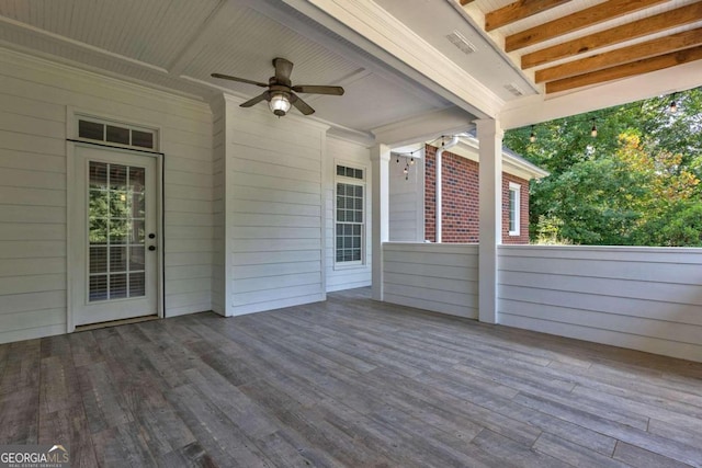 wooden deck featuring ceiling fan