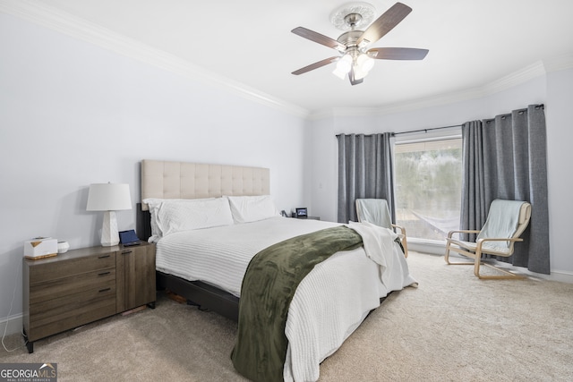 carpeted bedroom with ornamental molding and ceiling fan