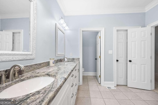 bathroom featuring toilet, ornamental molding, vanity, and tile patterned flooring