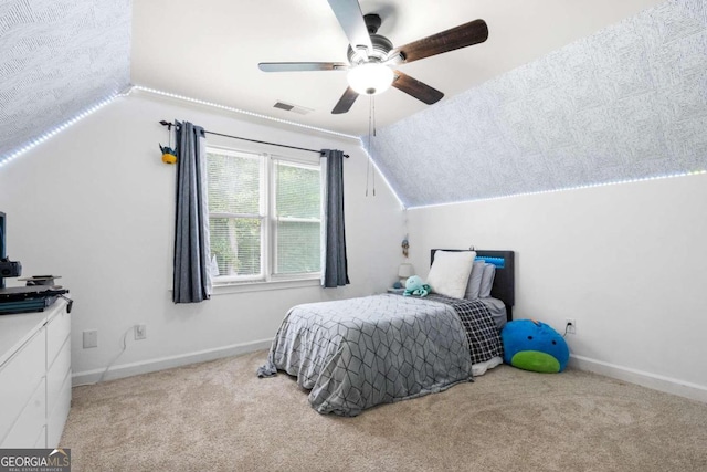 bedroom featuring lofted ceiling, light colored carpet, and ceiling fan