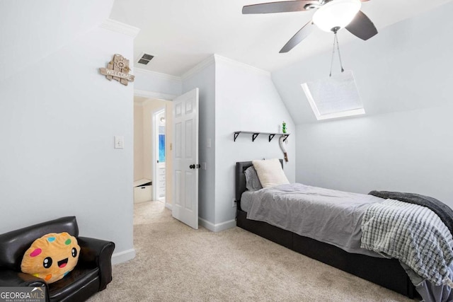 bedroom with lofted ceiling with skylight, crown molding, light colored carpet, and ceiling fan