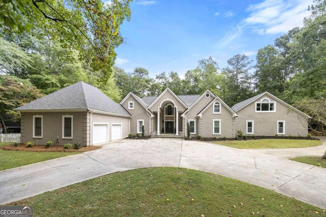 view of front of home with a front yard and a garage