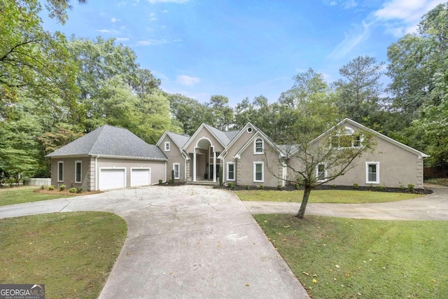 view of front of property featuring a front lawn and a garage