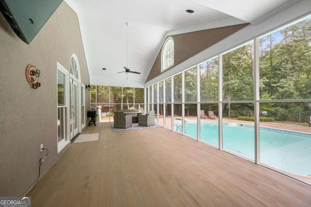 unfurnished sunroom featuring lofted ceiling and ceiling fan