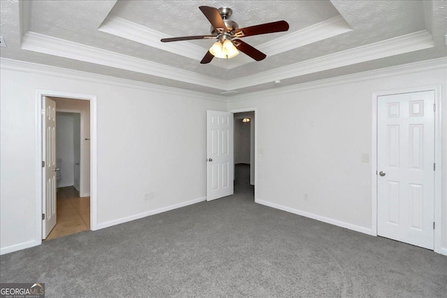 80 Stewart Hollow Ln, Covington, GA 30016 - unfurnished bedroom with a textured ceiling, carpet floors, a tray ceiling, and baseboards