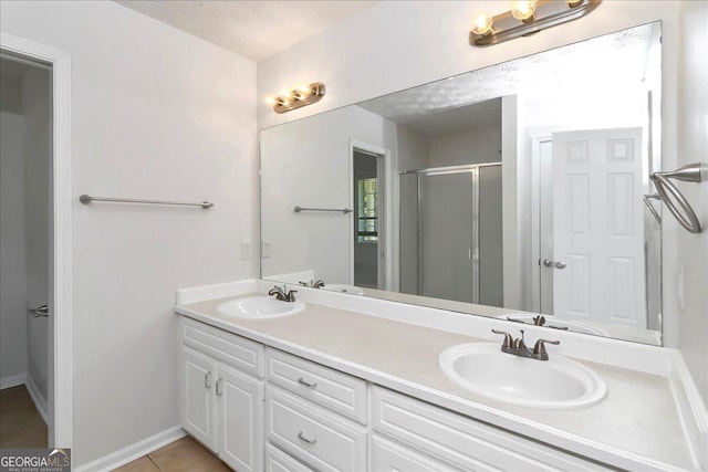 80 Stewart Hollow Ln, Covington, GA 30016 - bathroom with double vanity, a sink, tile patterned flooring, and a shower stall