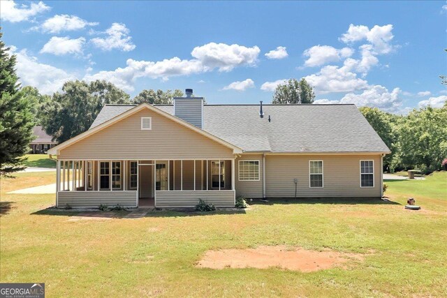 80 Stewart Hollow Ln, Covington, GA 30016 - back of house featuring a lawn, a sunroom, a chimney, and roof with shingles