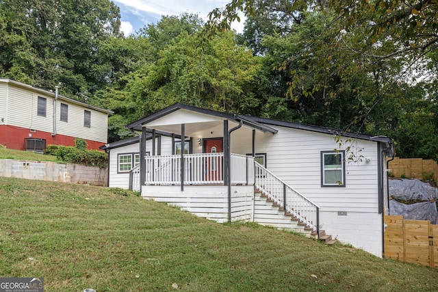 view of front of home featuring a front yard and central AC