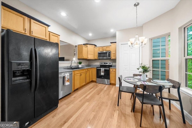 kitchen with pendant lighting, light hardwood / wood-style floors, appliances with stainless steel finishes, and plenty of natural light