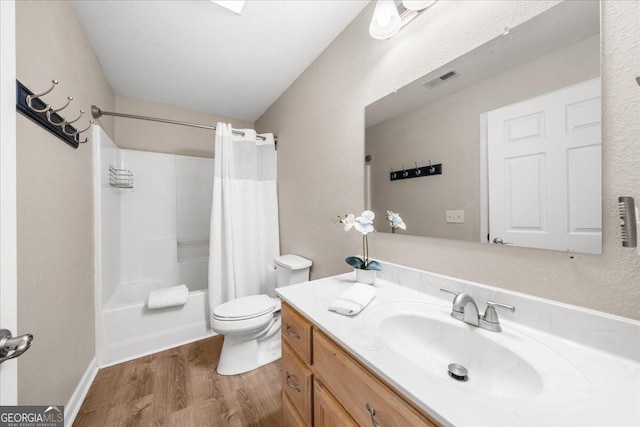 full bathroom with vanity, hardwood / wood-style floors, toilet, and shower / tub combo with curtain