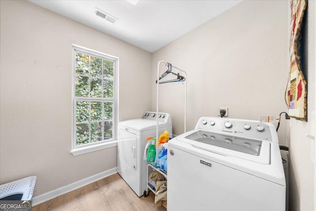 washroom with light wood-type flooring and independent washer and dryer