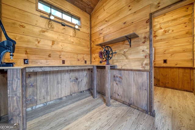 interior space with light hardwood / wood-style flooring and wooden walls