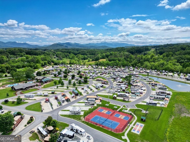 birds eye view of property with a water and mountain view