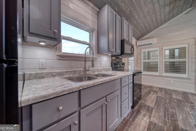 kitchen with black range with electric stovetop, lofted ceiling, sink, wooden walls, and a wall unit AC