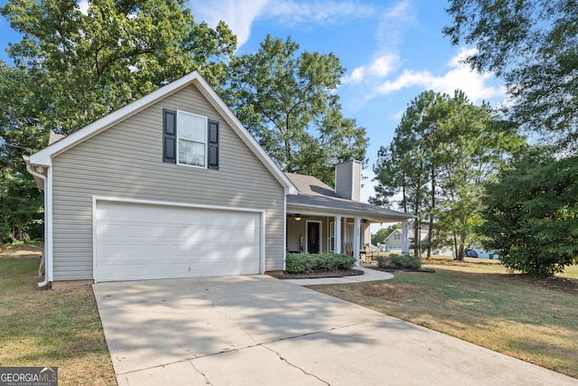 view of front of house featuring a garage, a front lawn, and covered porch