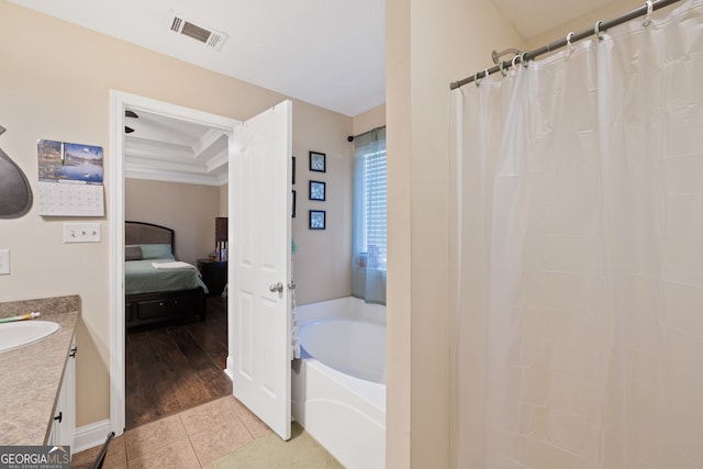 bathroom with wood-type flooring, vanity, and shower with separate bathtub