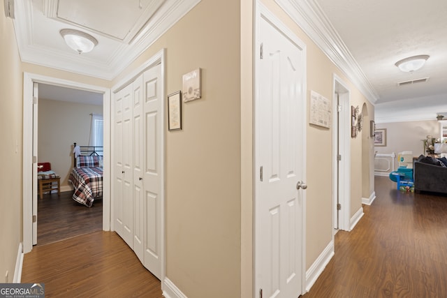 hall with wood-type flooring and crown molding