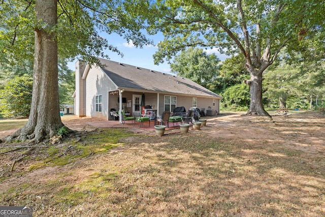 rear view of house with cooling unit and a patio area