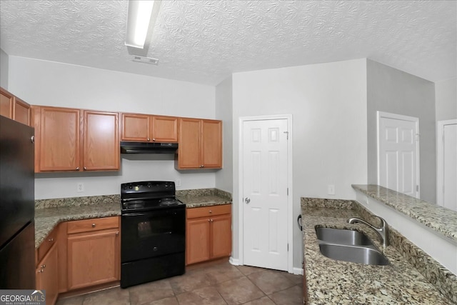 kitchen featuring tile patterned flooring, a textured ceiling, sink, black appliances, and stone countertops