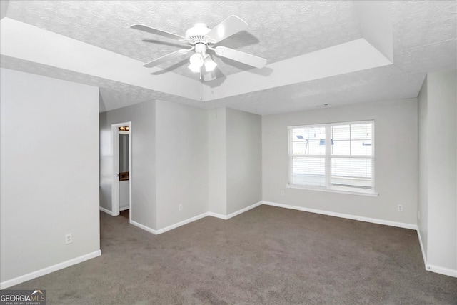 carpeted spare room featuring ceiling fan and a textured ceiling