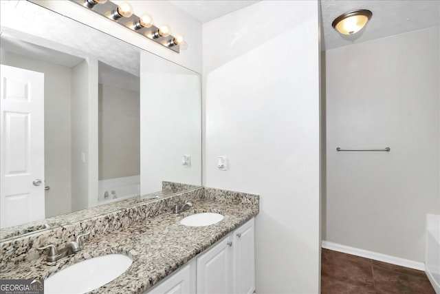 bathroom with vanity, tile patterned flooring, and a washtub