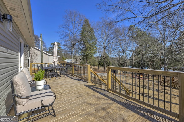 179 Bamboo Pt, Hartwell, GA 30643 - wooden deck featuring outdoor dining space and view of scattered trees