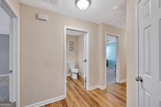 hallway with light hardwood / wood-style floors