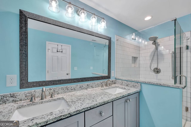 bathroom with vanity and a shower with shower door