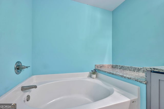 bathroom featuring vanity and a tub