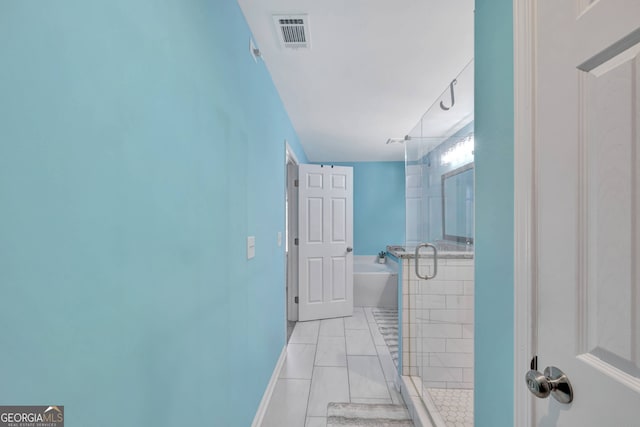 179 Bamboo Pt, Hartwell, GA 30643 - bathroom featuring a garden tub, a stall shower, and tile patterned floors
