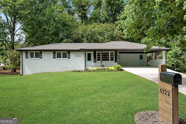 single story home featuring a carport and a front yard