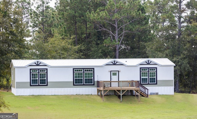 view of front facade with a front lawn and a deck