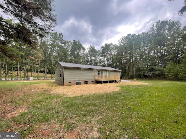 view of property exterior featuring a wooden deck and a lawn