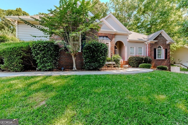 view of property hidden behind natural elements with a front lawn