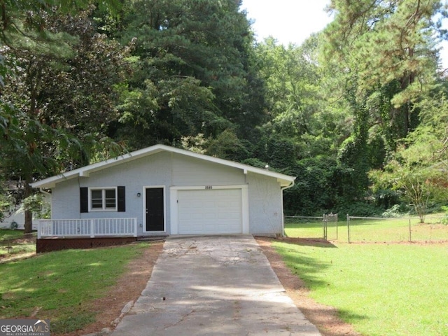 view of front of house with a garage and a front lawn