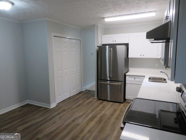 kitchen featuring a textured ceiling, sink, white cabinetry, stainless steel refrigerator, and dark hardwood / wood-style flooring