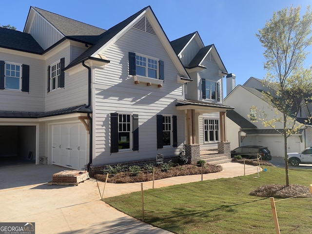 view of front of house featuring a garage and a front yard