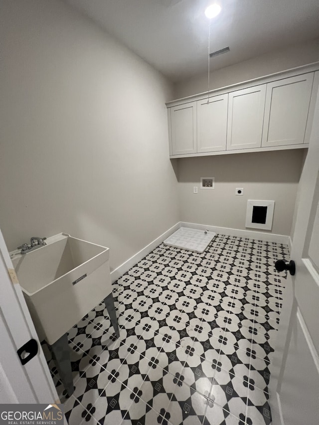 washroom with hookup for an electric dryer, cabinets, sink, and washer hookup