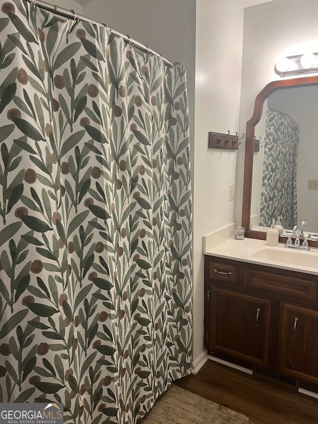 bathroom with hardwood / wood-style floors and vanity