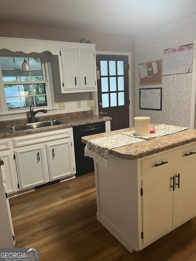 kitchen featuring black dishwasher, sink, white cabinets, and dark hardwood / wood-style flooring