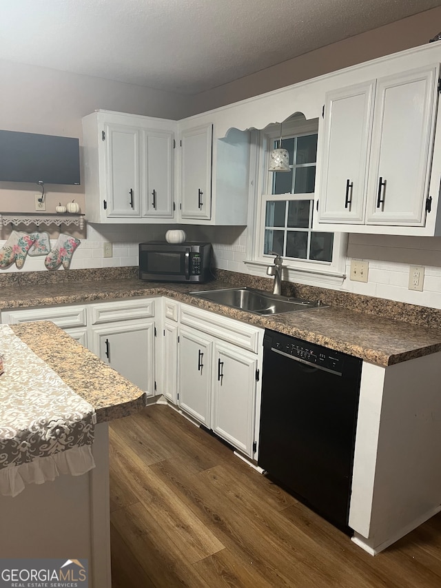 kitchen featuring black dishwasher, sink, white cabinets, backsplash, and dark hardwood / wood-style flooring