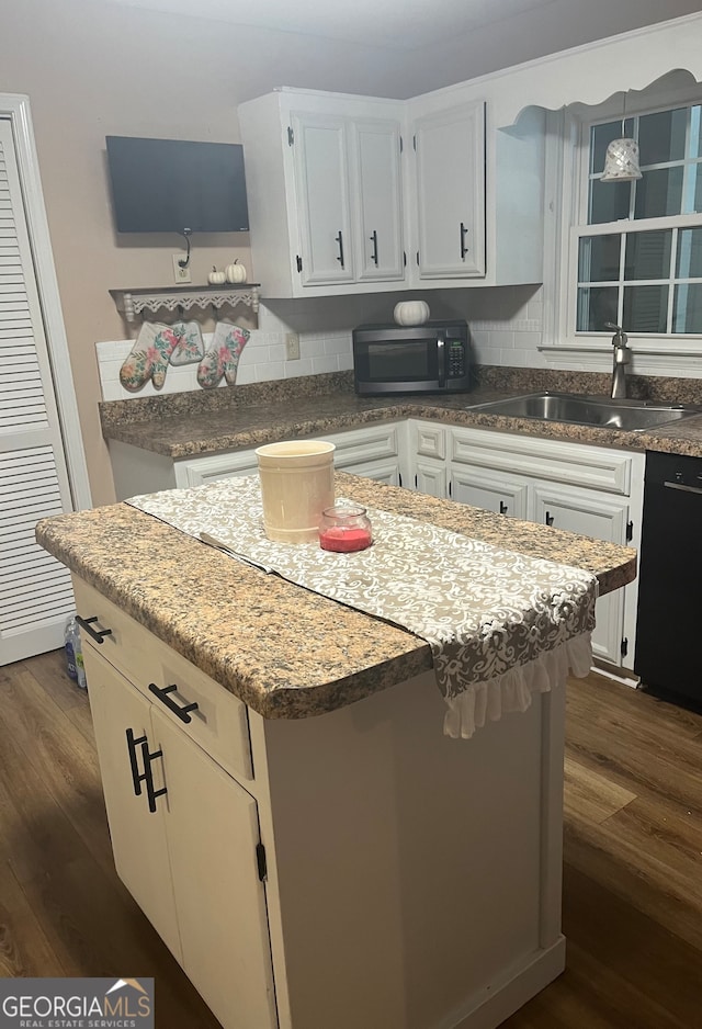 kitchen with a kitchen island, dark hardwood / wood-style floors, and white cabinets