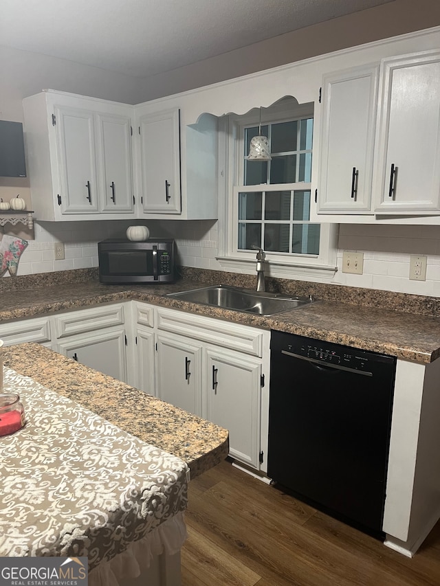 kitchen with white cabinets, black dishwasher, and sink