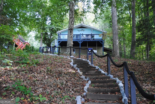 back of house featuring a wooden deck