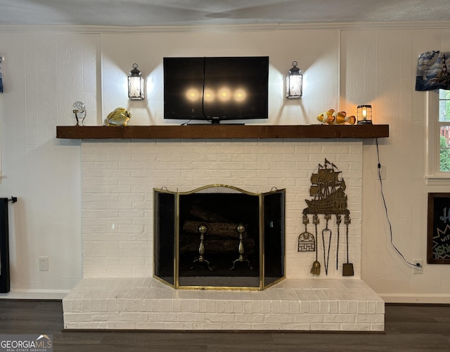 interior details with ornamental molding, a fireplace, and wood-type flooring