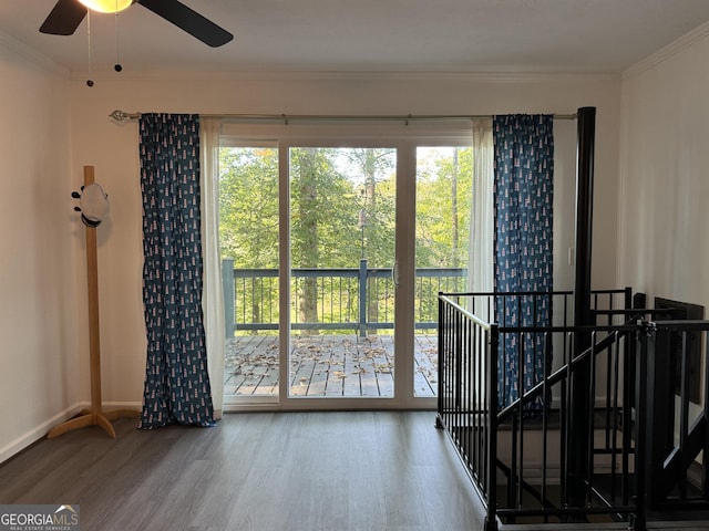 doorway to outside with ceiling fan, crown molding, and hardwood / wood-style floors