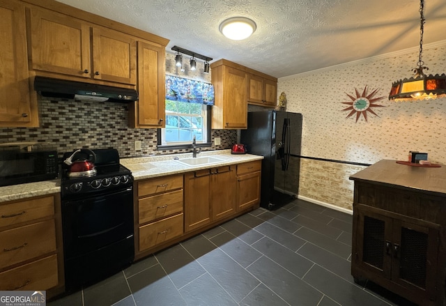 kitchen with black appliances, a textured ceiling, decorative backsplash, sink, and decorative light fixtures