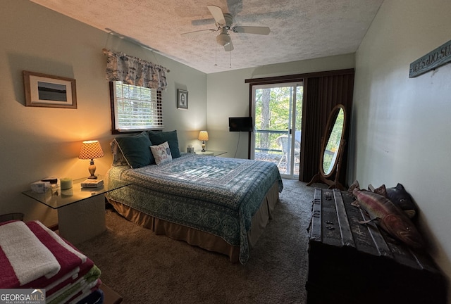 carpeted bedroom with ceiling fan, access to exterior, and a textured ceiling