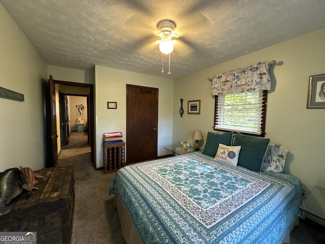 carpeted bedroom with ceiling fan and a textured ceiling