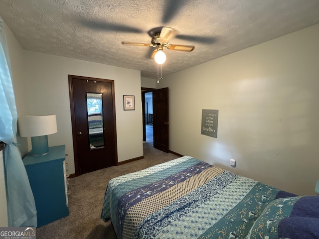 carpeted bedroom with ceiling fan and a textured ceiling